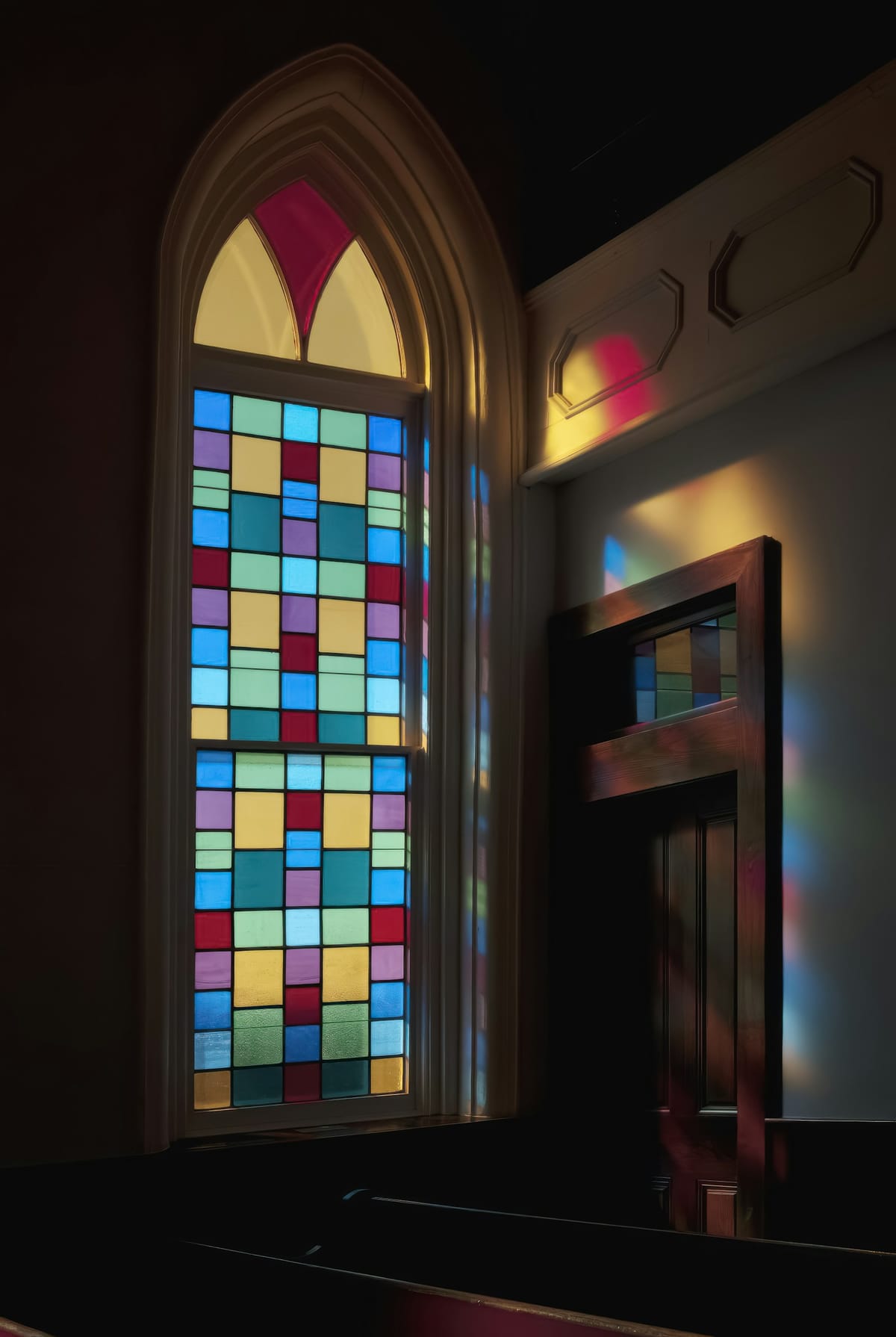 Colored glass panes beside a wooden door